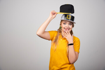 Smiling woman in yellow t-shirt and a cap