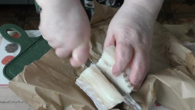 the cook cuts into pieces sea fish cod