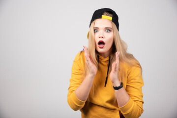 Portrait of cute woman in hoodie posing with a stylish cap