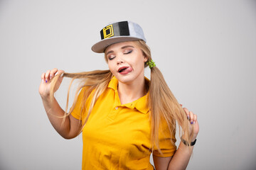 Portrait of cute woman posing with a gray stylish cap