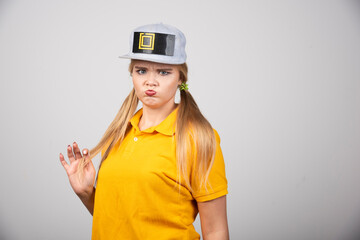 Portrait of cute woman posing with a gray stylish cap