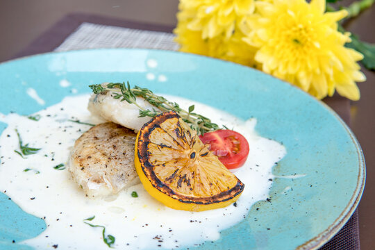 Fried Walleye Fillet, In Creamy Sauce With Microgreens And Lemon