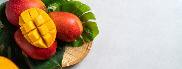 Mango background design concept. Top view Diced fresh mango fruit on gray table.