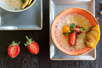 Healthy breakfast in a bowl with homemade baked granola, fresh strawberries