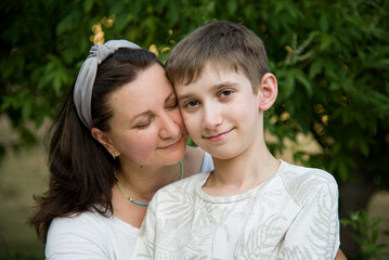 Fototapeta premium portraite of smiling happy mother with his son in summer park