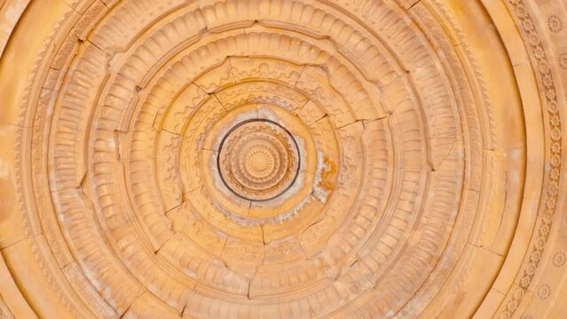 4K shot of the carved dome of the cenotaphs from below at Bada Bagh in Jaisalmer, Rajasthan, India. Ancient carvings on the roof of the dome made out of sandstone. Carved ceiling at Bada bagh cenotaph