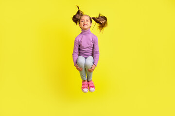 Fototapeta na wymiar Full size photo of lovely pretty kid girl jumping high isolated vivid bright color background
