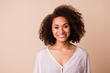 Photo of cheerful stunning lady toothy beaming smile nice curly hairstyle isolated on beige color background