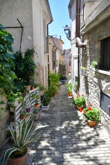 A narrow street between the old houses of Pietrelcina a village in the province of Benevento, Italy.	