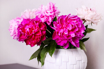 Bouquet of colorful peonies in vase