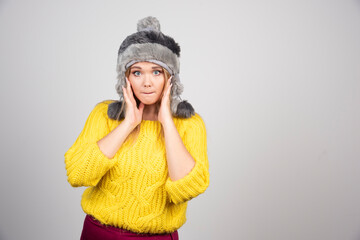 Blonde woman in winter hat looking at camera
