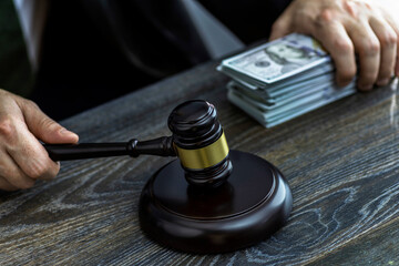 Fototapeta na wymiar Judge and money concept. Judge's gavel on the table. Judge's hammer for verdict, justice judgment at courts of law. American One Hundred Dollar Bill, corruption, cost, finances, expenses, salary