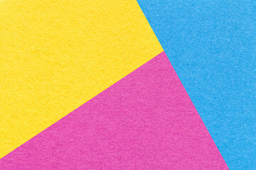 Texture of craft yellow, blue and purple shade color paper background. Structure of abstract magenta cardboard