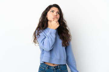 Teenager Russian girl isolated on white background having doubts