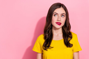 Photo of serious millennial brunette lady bite lip wear yellow t-shirt isolated on pink background