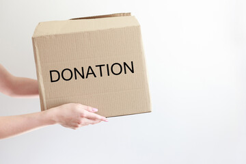 box with donations in hands on a white background