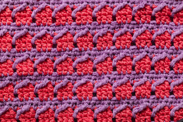 Pink purple seamless knitted texture. Volumetric crochet striped pattern. Knitted background.