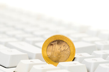 Euro coin on computer keyboard background
