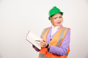 Female builder in helmet with tablet on white background