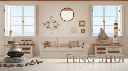 White table shelf with pebble balance and 3d letters making the word feng shui over living room with sofa and panoramic windows, marine style, zen concept interior design