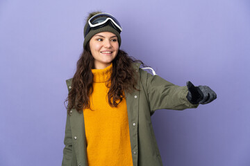 Teenager Russian girl with snowboarding glasses isolated on purple background giving a thumbs up gesture