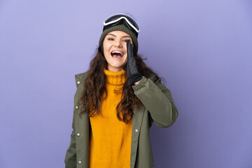 Teenager Russian girl with snowboarding glasses isolated on purple background shouting with mouth wide open