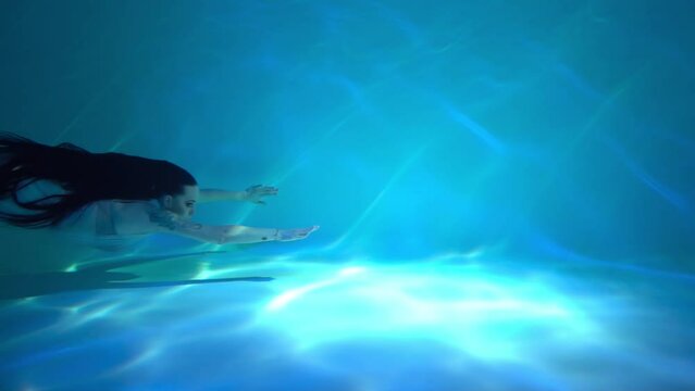 Slow Motion Woman in a sequin dress underwater