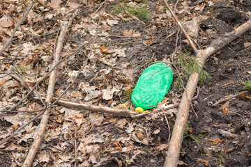 A crushed plastic bottle left in the forest