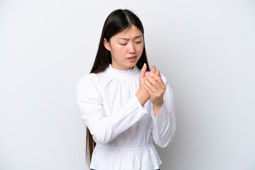 Young Chinese woman isolated on white background suffering from pain in hands