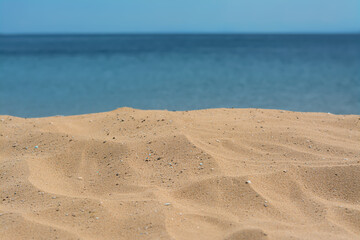 Closeup view of sandy beach near sea on sunny day