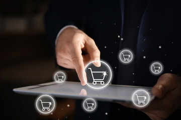 Delivery concept. Man using modern tablet for online shopping indoors, closeup. Market cart illustrations