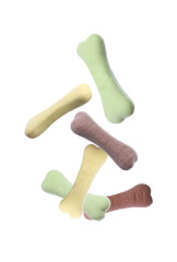 Bone shaped cookies for dogs falling on white background