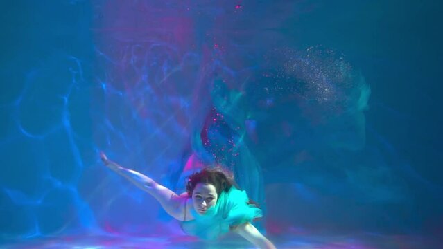 Slow Motion Girl underwater in white. lightness, freshness and health.