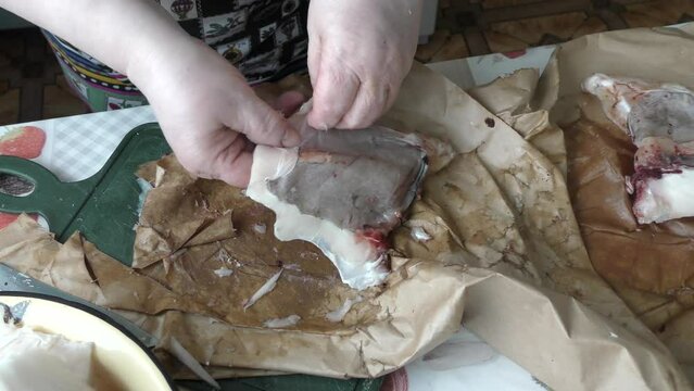 the cook cuts into pieces sea fish cod