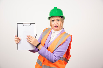Female builder in hardhat with tablet on white background