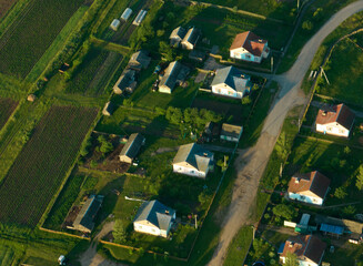 Country houses in countryside, aerial view. Rural building and farmhouse in countryside. Сountry House. Suburban house in rural. Roofs of village home. Agricultural development. Village wooden house.