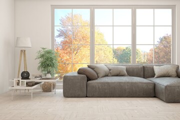 Fototapeta premium Stylish room in white color with sofa and autumn landscape in window. Scandinavian interior design. 3D illustration