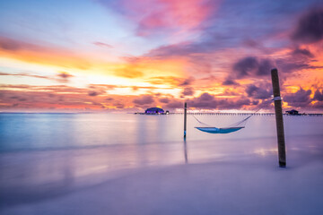 Tropical beach sunset as summer landscape with luxury resort beach swing or hammock and water...