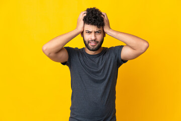 Young Moroccan man isolated on yellow background doing nervous gesture