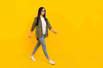 Full body photo of nice millennial lady go wear spectacles shirt jeans shoes isolated on yellow background