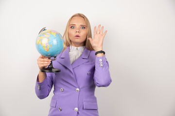 Female teacher holding globe on white background