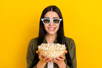 Photo of sad young lady watch movie hold pop-corn wear khaki shirt eyewear isolated on yellow background