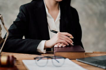 Woman judge hand holding gavel to bang on sounding block in the court room