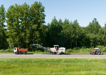 Cold milling during road construction and asphalt repair. Cold milling machine for the removal of asphalt and concrete pavements. Removing and grinding the road surface, road construction..