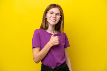 Young English woman isolated on yellow background giving a thumbs up gesture
