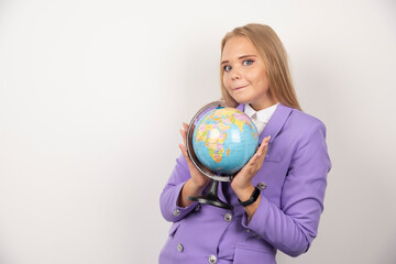 Fototapeta premium Beautiful teacher holding globe on white background