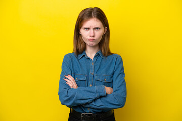 Young English woman isolated on yellow background with unhappy expression