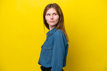 Young English woman isolated on yellow background . Portrait