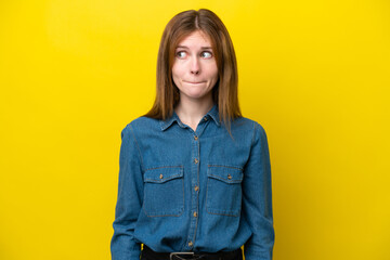 Young English woman isolated on yellow background having doubts while looking up