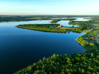 Lake in rural, aerial view. Freshwater Lakes. Abandoned Trinity Church in village of Belaya Tserkov. Lake Chereiskoye in Chereya village. Lighthouse on island. Panoramic landscape view of river.